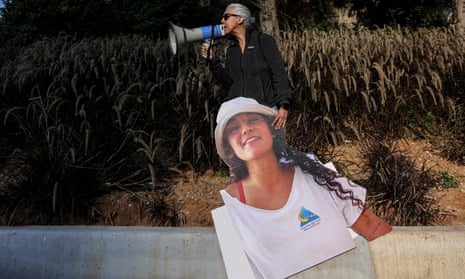 A woman holds a cutout picture of British-Israeli hostage Emily Damari.