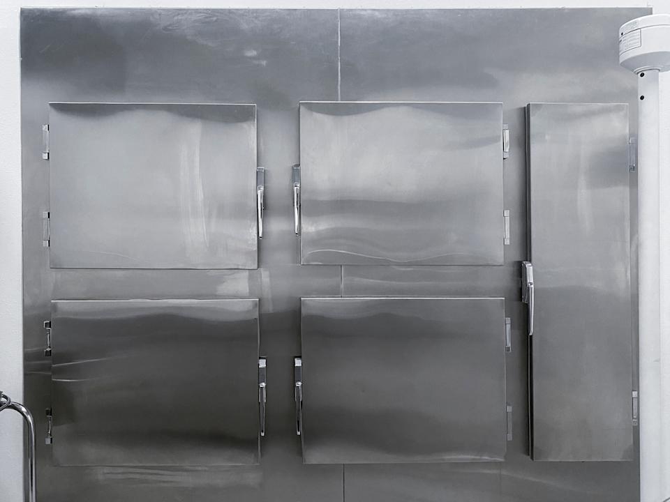 A row of stainless steel industrial doors, possibly related to refrigeration or storage