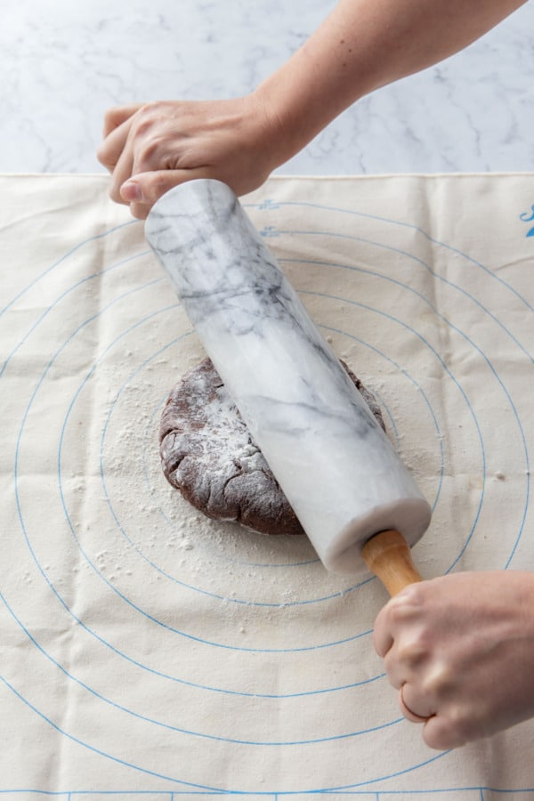 Rolling out the chilled chocolate pie dough on a lightly floured pastry cloth.