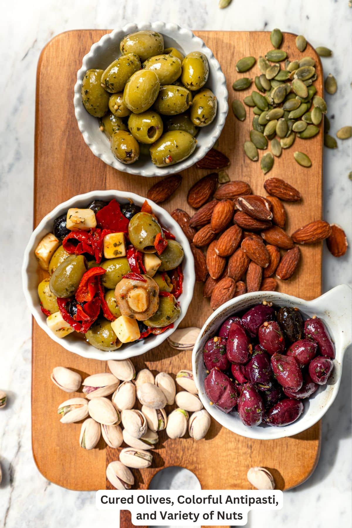 Your ultimate guide to creating a charcuterie and cheese board! I'll show you how to choose and arrange everything for a beautiful spread. Olives and nuts for charcuterie board.